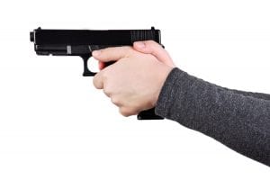 Close up of female hands aiming gun on a white background